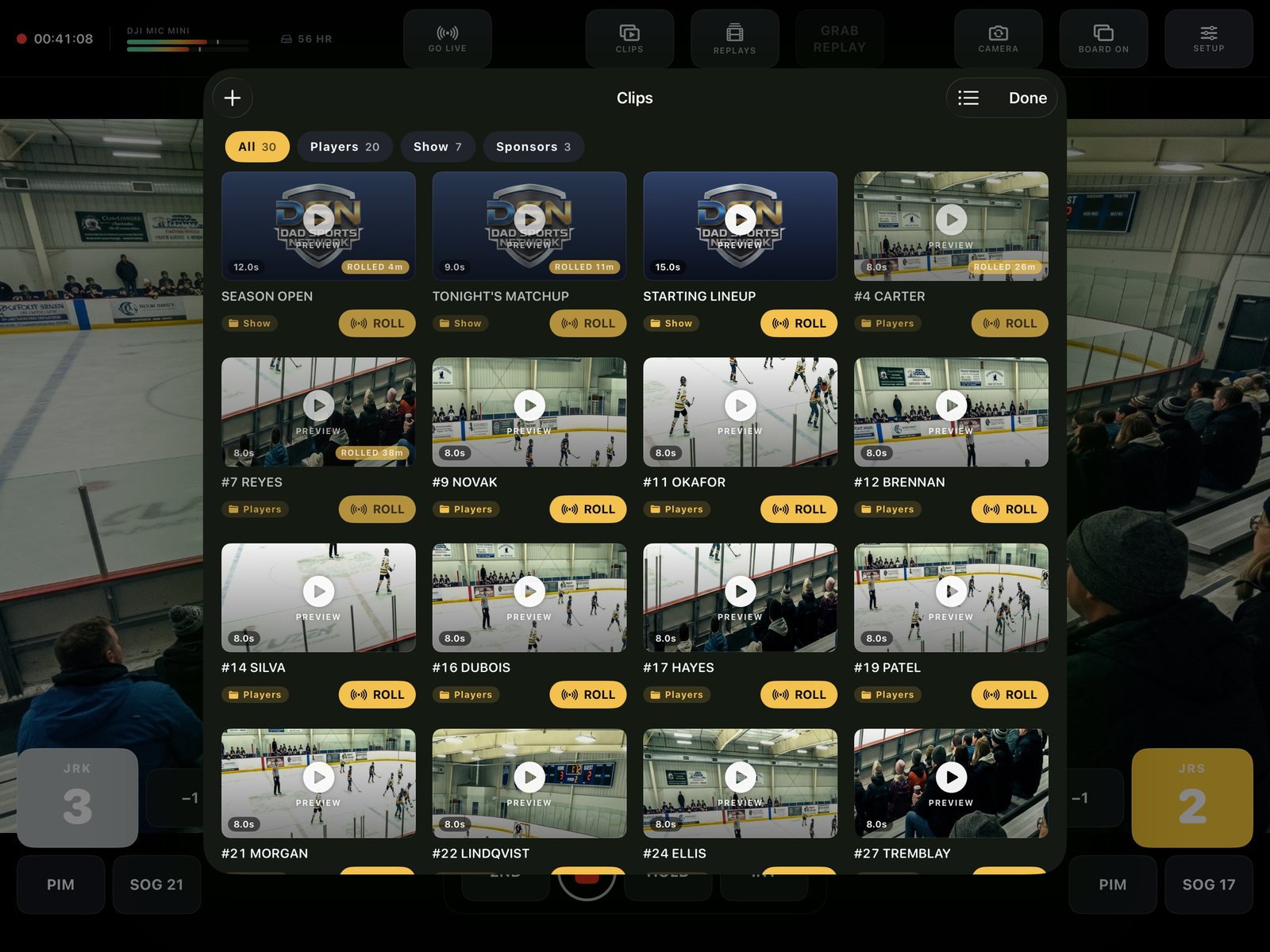 The clip bin open over a live hockey game: a grid of thumbnails filed into Players, Show and Sponsors groups, each with a one-tap ROLL button.